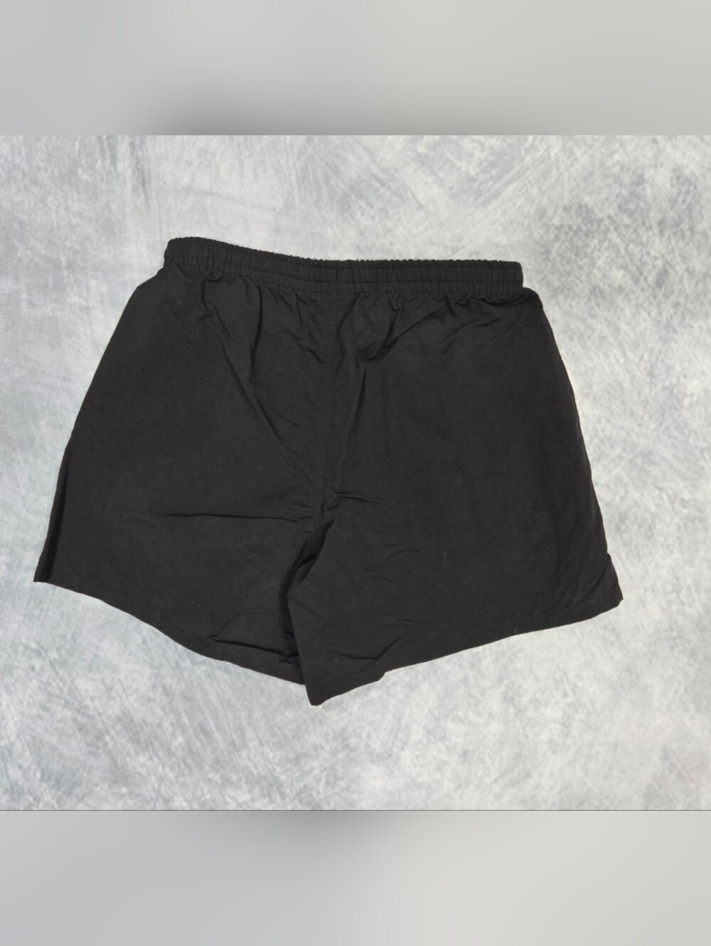 Patagonia Baggies shorts featuring a prominent woven logo patch on the left leg. - Picture 2 of 3